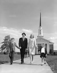 Family walking past church